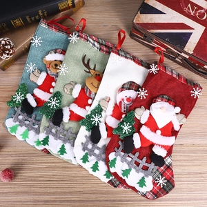 Detailed view of four burlap Christmas stockings with 3D Santa, Snowman, and Reindeer motifs