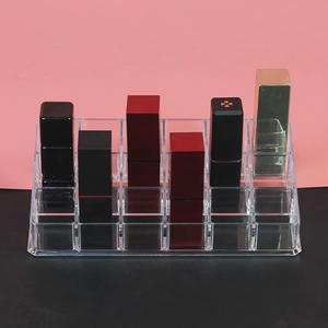 Top view of a 24-slot clear acrylic lipstick organizer showing multiple makeup compartments