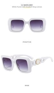 Detail of white square sunglasses with golden Greek fret pattern on chain temples