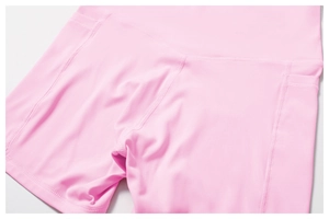 Close-up of pink high-waisted yoga shorts with side pockets and flatlock stitching