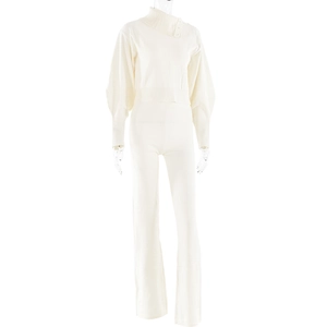 Detail view of cream knit two-piece set featuring a high neck collar with button accents