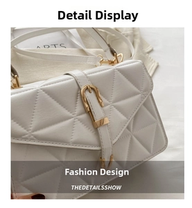 Close-up of white quilted leather handbag featuring refined gold hardware and stitching
