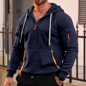 Detail of navy blue hoodie featuring orange zipper and utility sleeve pocket