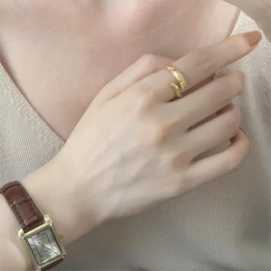 Close-up of irregular gold 925 sterling silver ring with organic texture on model hand
