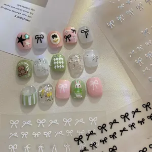 Close-up of bow and bear patterns on pink and green nail stickers for nail art