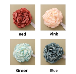 Detail view showing red, pink, green and blue rose shaped PE mesh bath loofah sponges