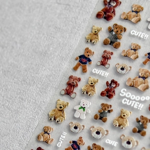 Macro shot of 3D embossed cute bear nail stickers with textured brown cartoon designs