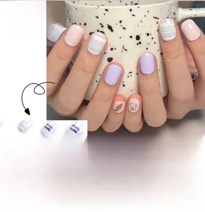 Macro detail of Easter bunny and carrot patterns on mini press-on nails for kids