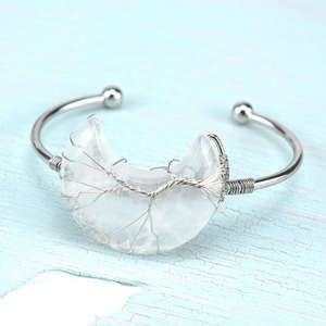 Detail of silver wire-wrapped tree of life moon bracelet with clear crystal