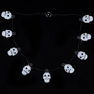 Detailed view of Halloween glowing skull string lights with translucent white finish