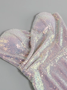 Macro detail of sequined fabric and sweetheart neckline on a luxury evening dress