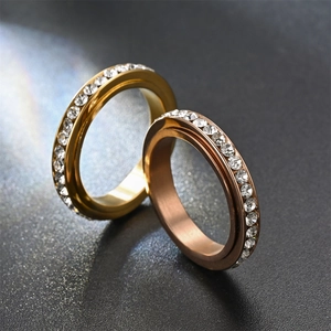 Vista macro de anillos giratorios en oro y oro rosa con pavé de circonitas cúbicas