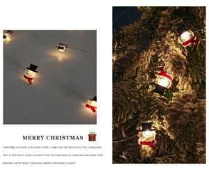 Detail of snowman LED Christmas lights with black hat and red scarf decoration