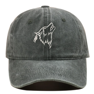 Close-up of wolf head embroidery on a vintage washed dark grey cotton baseball cap