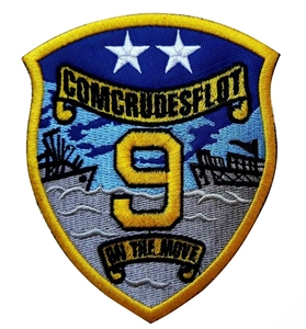 Macro view of Top Gun Maverick shield patch with blue embroidery and yellow border