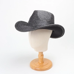 Detail view of a black sequin cowboy hat on a model stand with metallic finish texture