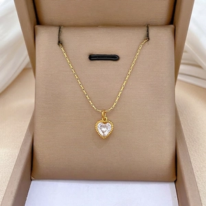 Gold heart pendant necklace with clear zircon stone in a luxury jewelry display box