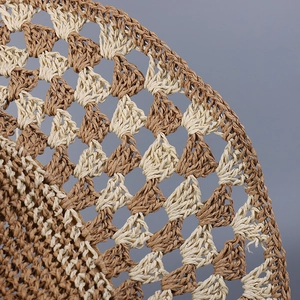 Close-up of bohemian crochet straw hat featuring brown and beige hollow woven patterns