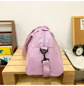 Side view of lavender large capacity duffel bag showing strap attachment detail