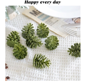 Detail of green plastic pine cone ornaments on white grid cloth for home decoration