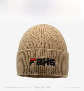 Close-up of khaki knit beanie featuring FBXS 3D letter embroidery and ribbed texture