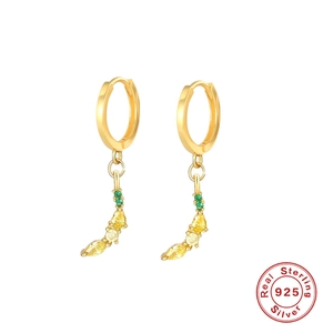Detail of S925 sterling silver banana hoop earrings with yellow and green zircon stones