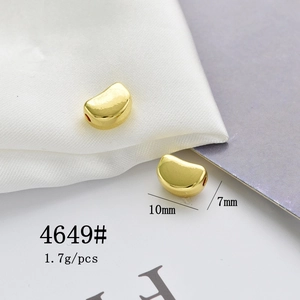 Macro shot of gold-plated bean-shaped pendant 10x7mm for DIY necklace and bracelet