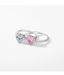 Detail view of heart-shaped sparkling silver rings with pink and clear gemstones