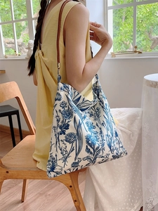 Vintage blue and white floral canvas shoulder bag with brown leather strap