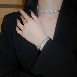Macro view of a luxury silver flower necklace and bracelet set with sparkling crystals