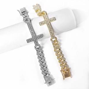 Close-up of gold and silver iced out Cuban link bracelets with diamond cross pendant