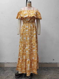 Detail view of yellow floral off-shoulder dress with tiered ruffle hem and vine patterns