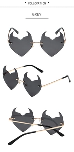 Three perspectives of heart-shaped devil sunglasses with grey lenses and gold metal frames