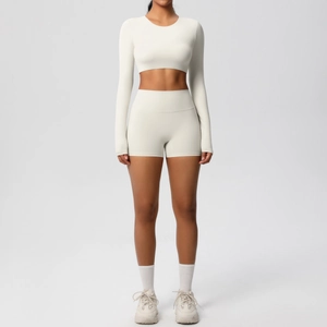 Detail view of seamless cream yoga set featuring long sleeve crop top and high waist shorts