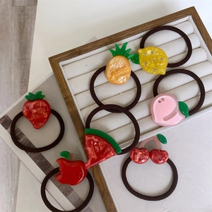 Detailed set of 7 colorful acetate fruit hair ties including strawberry and lemon designs