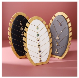 Bamboo necklace display board set with black, white, and grey velvet lining panels