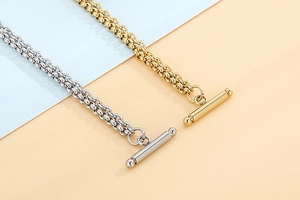 Detail of gold and silver double-layered chains with OT toggle clasp and heart rose design