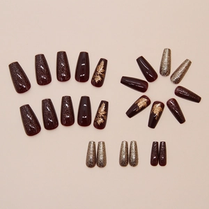 Autumn amber maple leaf press-on nails with glitter gold accents in long coffin shape