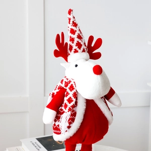 Detail of a Christmas reindeer plush toy with a red knitted hat and scarf decor