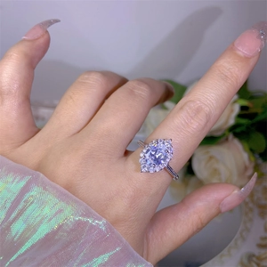 Elegant silver open ring with marquise zircon flower cluster shown on finger