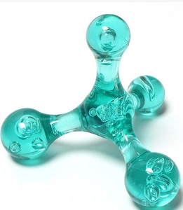 Macro detail of ergonomic cyan transparent plastic four-point handheld massager tool