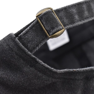Detail of adjustable metal buckle and strap on a washed cotton vintage baseball cap