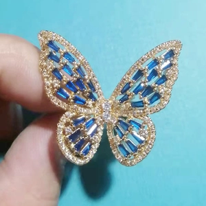Macro detail of butterfly ring with blue baguette stones and sparkling crystals
