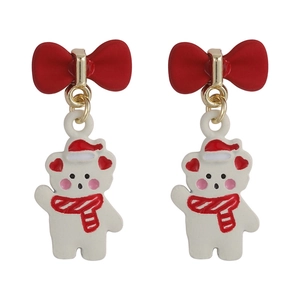 Detailed macro shot of Christmas bear earrings with red bows and enamel finish