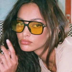 Detail of retro aviator sunglasses with yellow lenses and black double-bridge frame