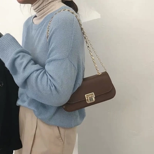 Retro brown leather shoulder bag with gold chain strap shown on model for daily style