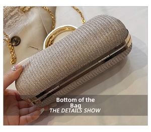 Detail shot of the sequined evening clutch bag bottom and golden metal frame hinges