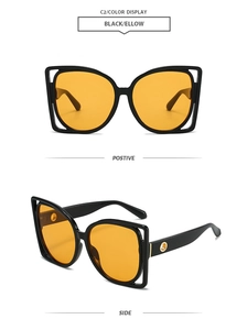 Détail de lunettes de soleil carrées oversize avec verres jaunes et accents dorés
