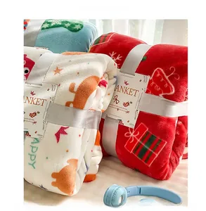 Detailed view of soft red Christmas flannel blanket with reindeer and snowflake patterns