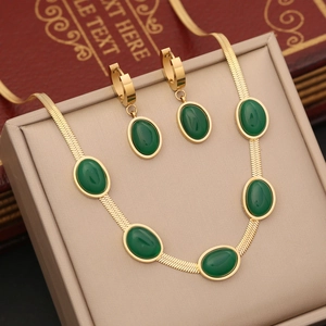 Golden stainless steel snake chain necklace and earrings set with green oval emerald stones